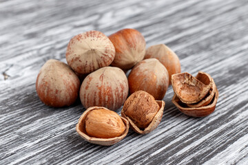 Hazelnuts on a black wooden table.