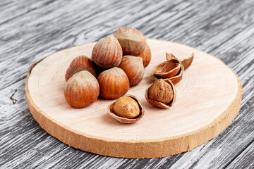 Hazelnuts on a wooden background.