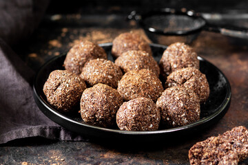 Chocolate coconuts. Chocolate balls with coconut. Chocolate candies or cookies with coconut, cinnamon and powdered sugar	