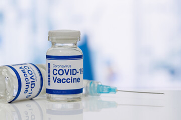 covid-19 vaccine in a medical research lab, a bottle of covid-19 vaccine, syringe for injection of vaccination, hand holding vaccine, covid-19 cure testing