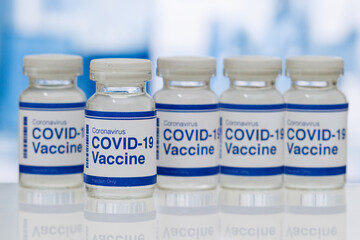 covid-19 vaccine in a medical research lab, a bottle of covid-19 vaccine, syringe for injection of...