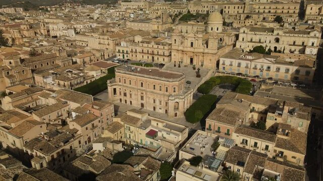 Drone makes the circle above the central street Vittorio Emanuele in Noto in Sicily. Aerial view of Cathedral of Noto (La Chiesa Madre di San Nicolò). Aerial view of the Ducezio Palace