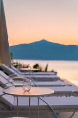 Beautiful tropical sunset scenery, sun beds, loungers, umbrella 