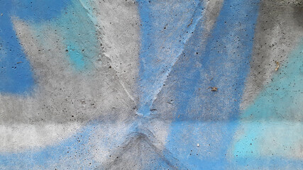 Concrete surface painted with blue paint. Blue stained plaster