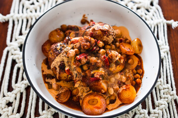 plant-based food, vegan potato and onion roast with chickpeas tomato sauce and herbs