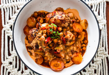 plant-based food, vegan potato and onion roast with chickpeas tomato sauce and herbs