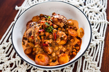 plant-based food, vegan potato and onion roast with chickpeas tomato sauce and herbs