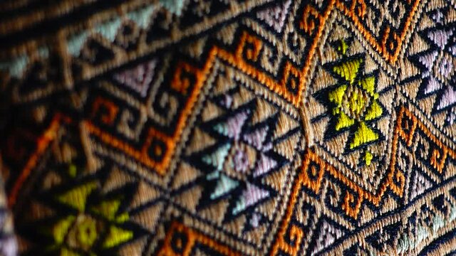 4K More than 100 years old colorful thai handcraft peruvian style rug surface old vintage torn conservation Made from natural materials Chemical free close up.