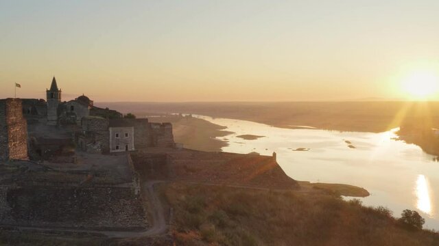 Juromenha castle, village and Guadiana river drone aerial view at sunrise in Alentejo, Portugal