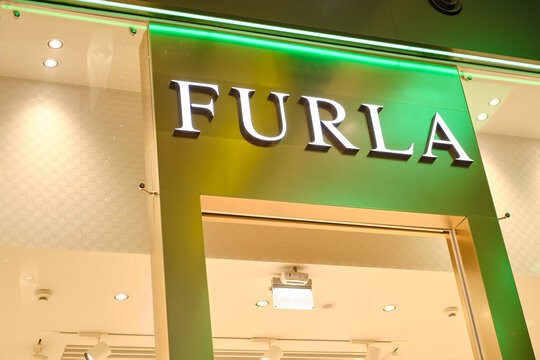 Furla sign hanging in front of a shop is an Italian luxury goods company - Moscow, Russia, December 17, 2020