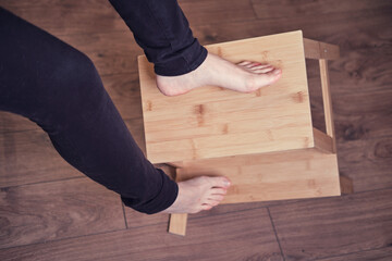 An adult woman falls off a stepladder due to a broken chair leg. Problems with labor protection when working at home