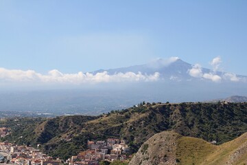 Fototapeta na wymiar view of Mount Etna, the hills, the mountains in front of the volcano and the town by the sea
