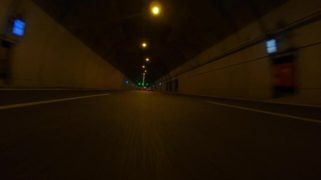 Time-lapse POV fast night video from illuminated highway tunnel