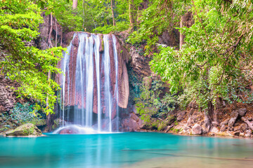 Beautiful waterfall and emerald lake in green tropical jungle forest. Nature landscape of Erawan National park, Kanchanaburi, Thailand