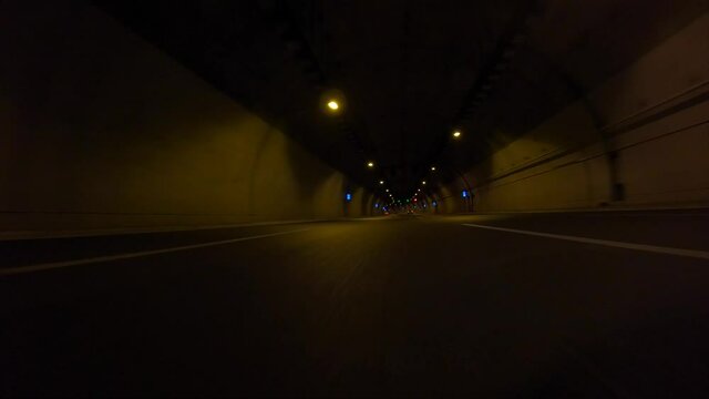 Time-lapse POV fast night video from illuminated highway tunnel