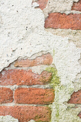 old cement wall in which you can see the bricks underneath, a concept of the inexorable passage of time. background with space for text and copy