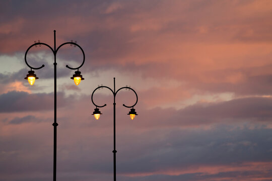 two lighted street lamps isolated at dawn. concept of the comment of a new life or idea. space for text and copy