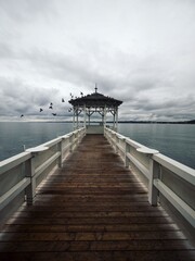 Lakeside waterfront esplanade pavilion gazebo elevated on wooden pier stilts in Lake Constance...
