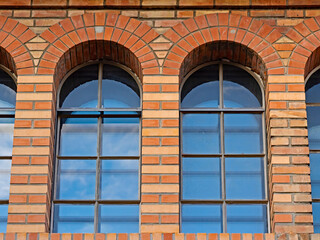 Arched window on the old brick facade
