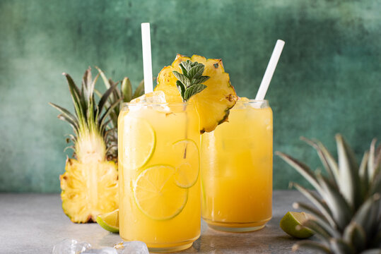 Freshly Squeezed Pineapple Juice With Lime Wedges And Ice