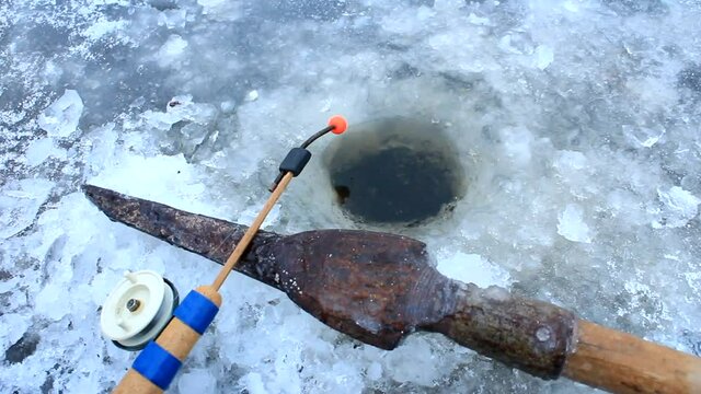 rod and gaff for winter fishing at the hole in the ice