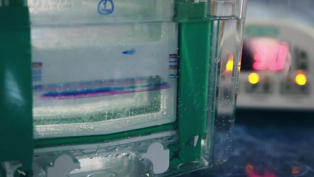 Gas bubbles are released in the liquid inside the transparent box during electrophoresis. Electrophoresis device.