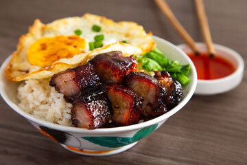 Chinese Sweet Bbq Pork is marinated in a sweet BBQ sauce and served with white rice.