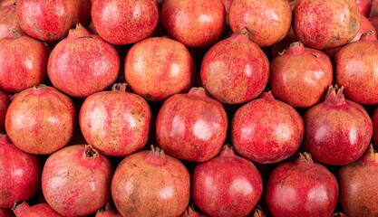Fresh red pomegranate placed in pattern order.