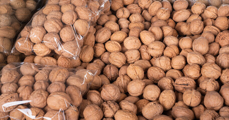  Large amount of fresh walnuts in the market for sale.