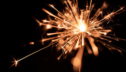 Sparklers flame, on black background, selective focus.