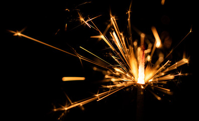 Sparklers flame, on black background, selective focus.