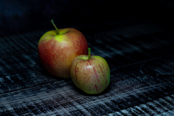 Two apples on a dark wooden background