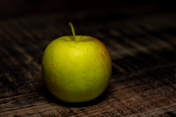 green apple on a wooden table