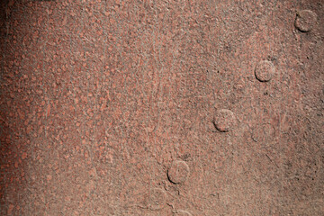 Rusted steel background with large rivets, heavy industrial texture, horizontal aspect