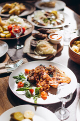 The restaurant table with Ukrainian and European cuisine is served with various delicious dishes for the reception