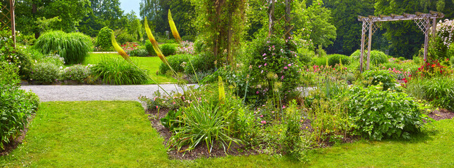 Beautiful spa park in Bad Wörishofen with flower beds and roses, Germany, Bavaria.