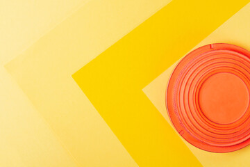 Clay target for skeet shooting against the colorful yellow background. Clay pigeon shooting. Copy...
