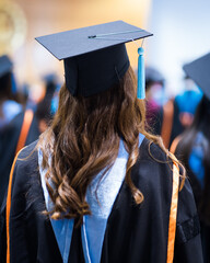 Rearview of the university graduates line up for degree award in university graduation ceremony....