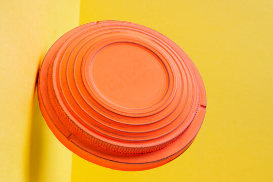 Clay disc target for skeet shooting flying against the colorful yellow background. Clay pigeon shooting