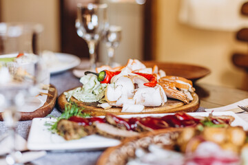 a large clay plate with a national Slavic delicacy - thinly sliced lard with spices on the table...