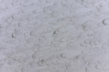 Dirty gray wall, background texture. Out of focus, possible granularity, motion blur