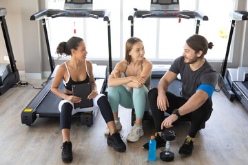 Group of diversity sports people talking and laughing happy together after workout at gym. Healthy Lifestyle and Sport Concepts.