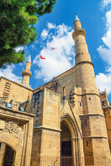 Fototapeta na wymiar Selimiye Mosque or Cathedral of Saint Sophia or Ayasofya Mosque building with minarets in North Nicosia historical city centre, blue sky white clouds background, Cyprus