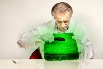 Museologist examining artifact of emerald tablet on his workplace