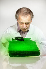 Museologist examining artifact of emerald tablet on his workplace