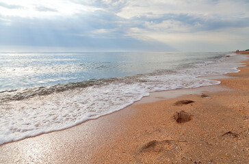 Summer sea beach with footprints in the foreground. Azov sea; Ukraine.