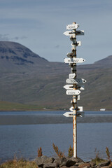 The country location sign at the shore of Eskifjordur town in East region of Iceland