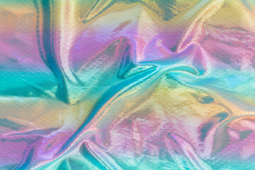 Holographic iridescent surface wrinkled cloth. Real Hologram Background of wrinkled abstract foil 80s texture with multiple colors. holographic style texture,reflective fabric multicolored iridescent