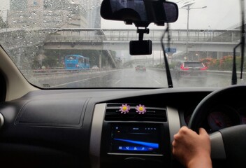 person driving cars in heavy rain conditions