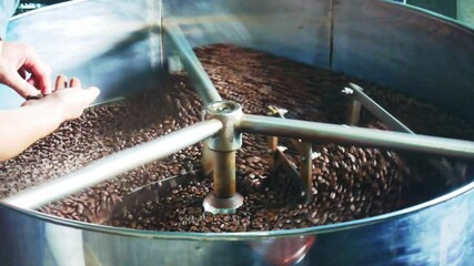Coffee roaster machine at coffee roasting process.